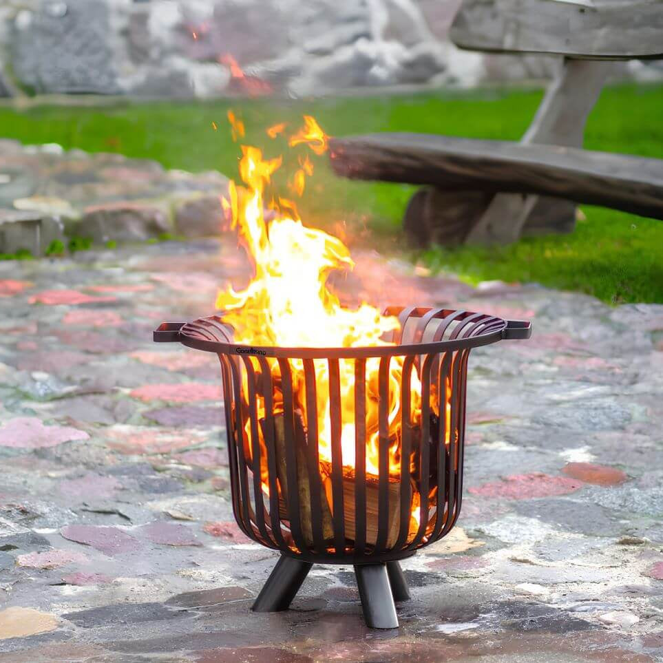 CookKing Feuerkorb Verona – Feuerkorb mit brennenden Holzscheiten auf Gartenpflaster