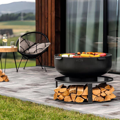 Feuerschale CookKing XXL PALERMO – Feuerschale mit Grillplatte und gefüllter Holzablage auf einer Terrasse