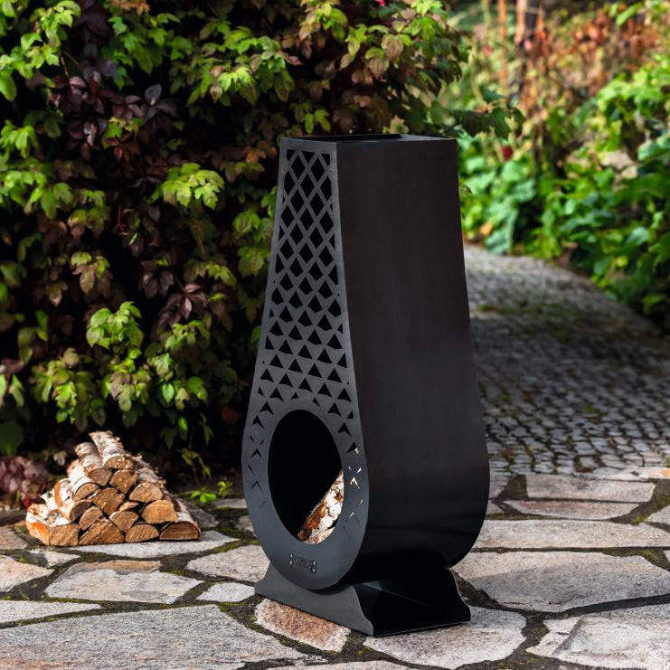 CookKing Gartenofen Avangardo – Gartenofen mit Holzscheiten in seitlicher Ansicht im Garten