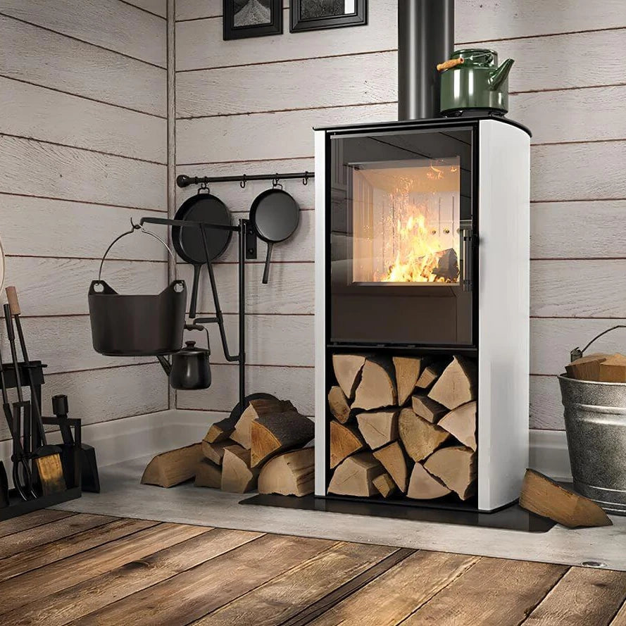 Kaminofen Hitze Cane S 6,5 kW – Kaminofen mit weißer Seitenverkleidung, Feuer und Holzfach vor einer Holzwand